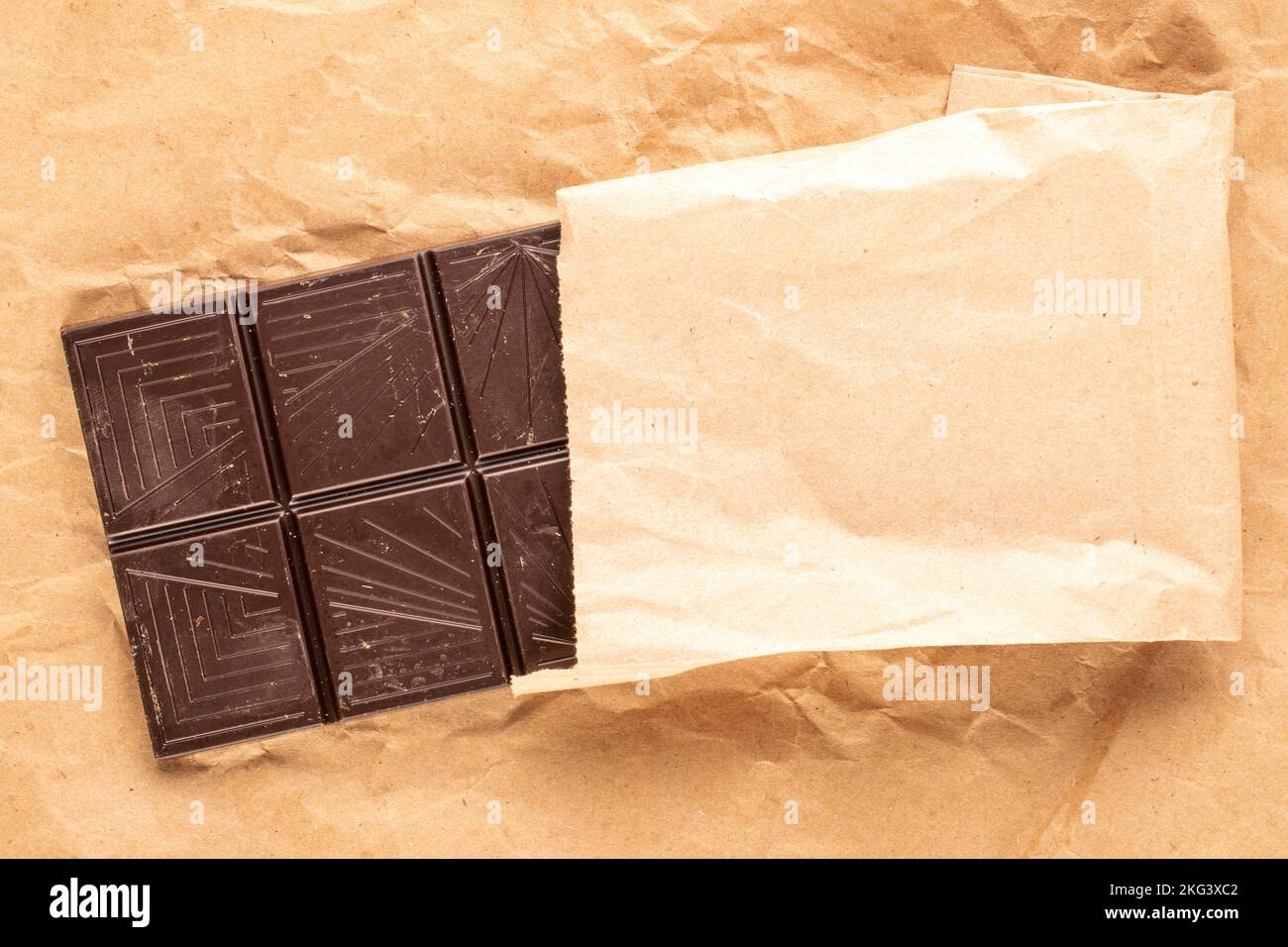 One bar of bitter dark chocolate on kraft paper, macro, top view Stock ...