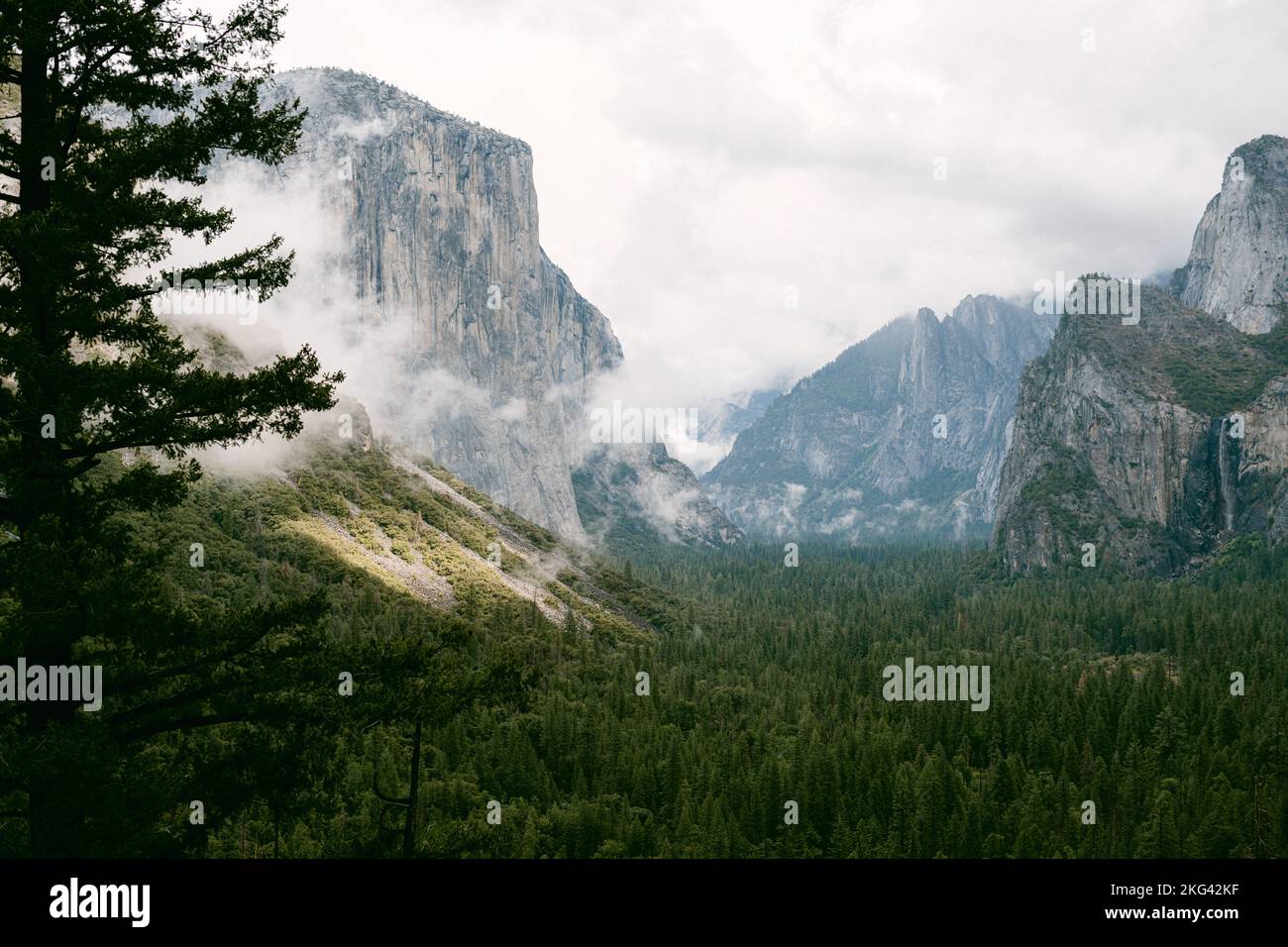 Sun shining through clouds in Yosemite Valley Stock Photo