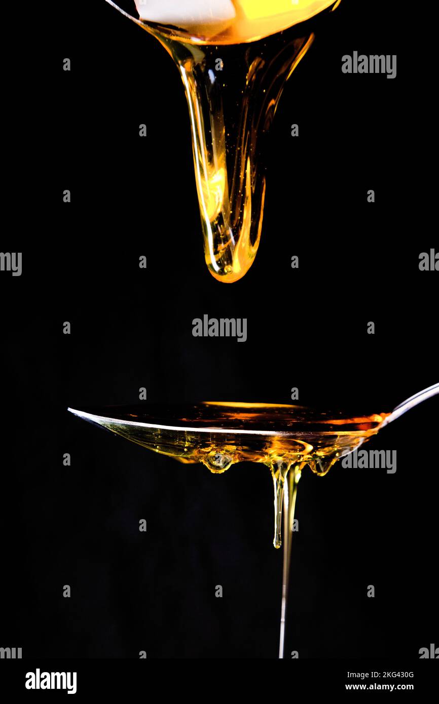 honey drizzling onto a spoon Stock Photo - Alamy