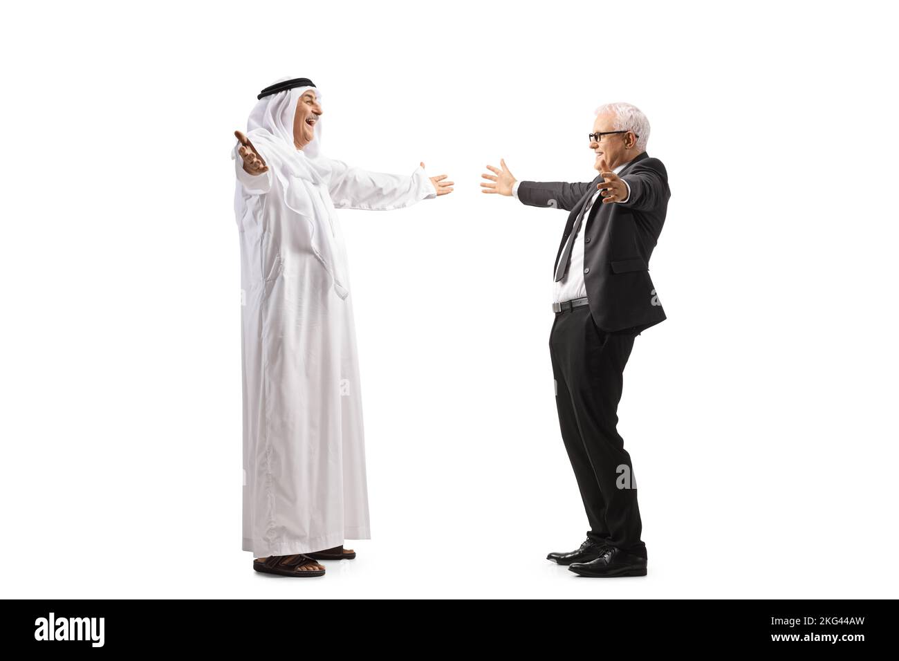 Full length profile shot of a mature arab man in a robe meeting a businessman friend isolated on white background Stock Photo