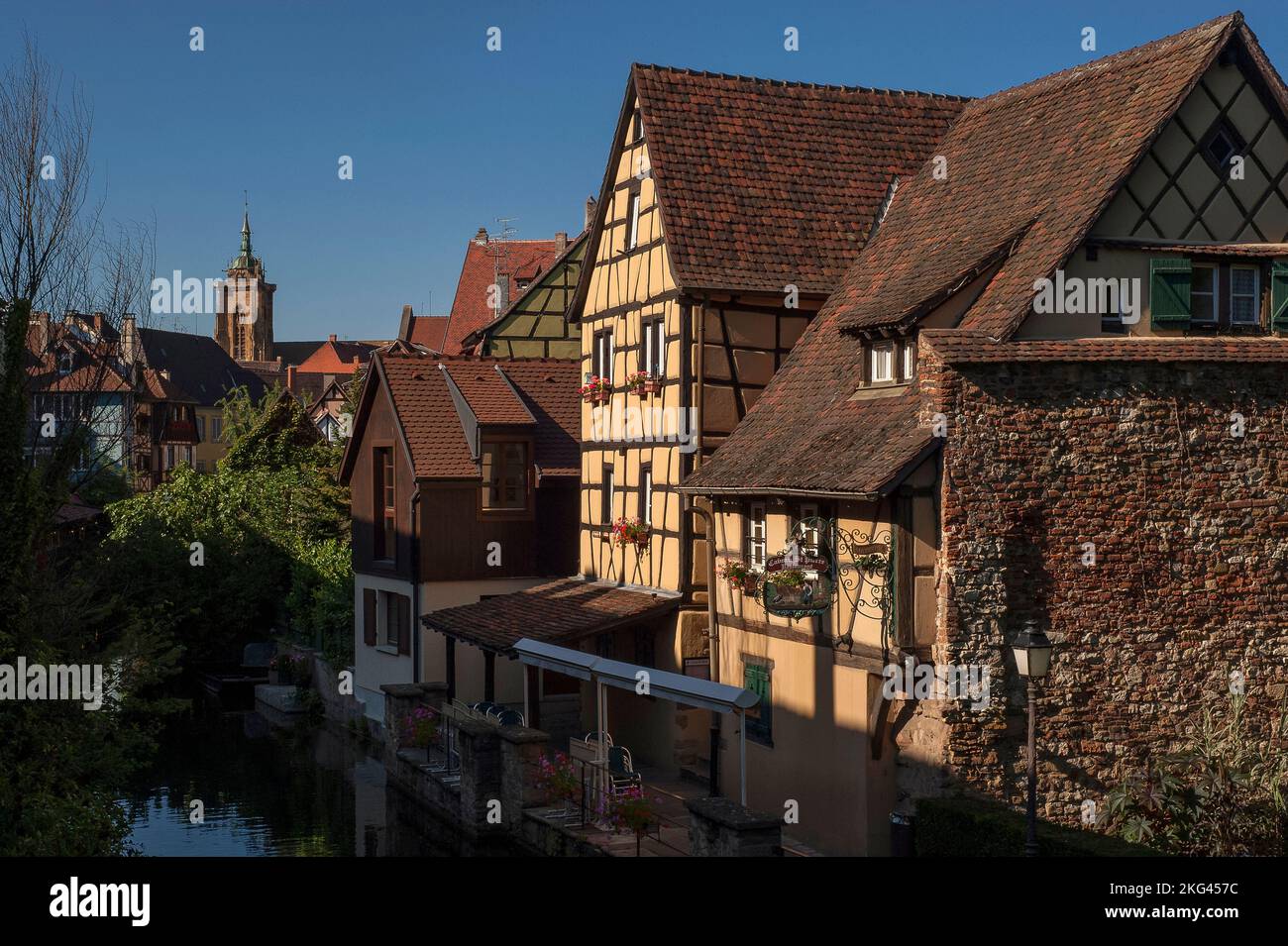 The Caveau Saint-Pierre restaurant, in a large 16th century typically Alsatian timber-framed house, offers waterfront dining beside the River Lauch in the picturesque Little Venice (La Petite Venise) area at Colmar, Alsace, Grand Est, France. Stock Photo