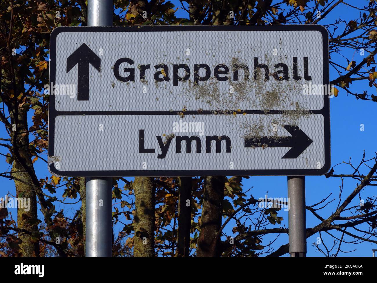 Sign to Grappenhall (straight on) and Lymm (to the right) villages, Warrington, Cheshire, England, UK, WA4 1NN Stock Photo