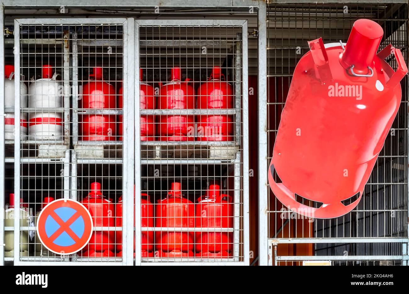 Gas crisis. Gas cylinders stored in a cage. Gas cylinders locked behind grid Stock Photo