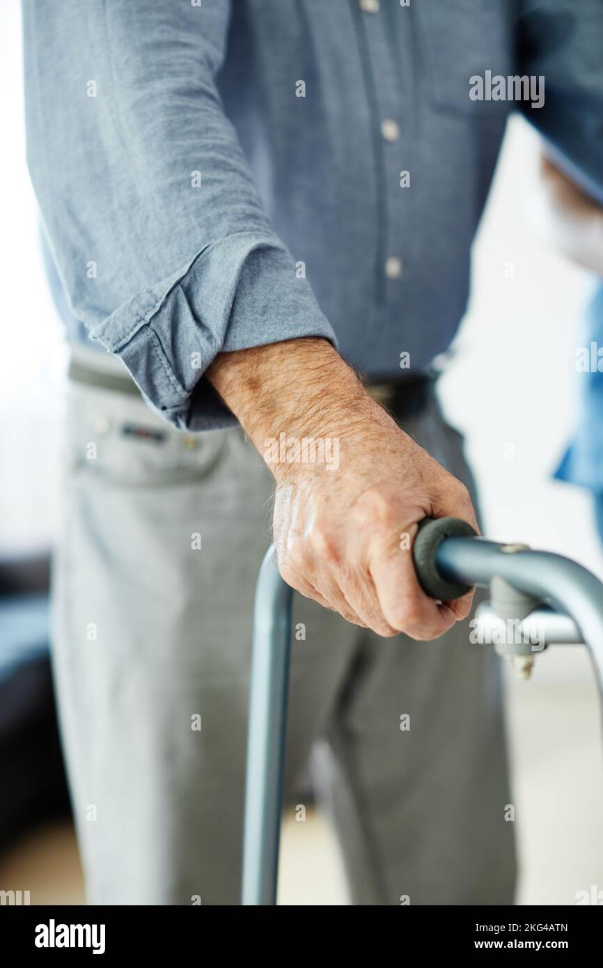 nurse doctor senior care caregiver help walker assistence retirement home nursing elderly man Stock Photo