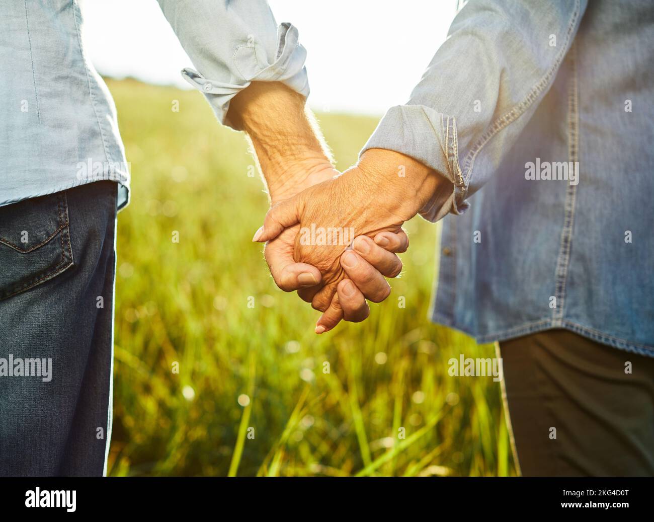 woman man outdoor senior couple happy lifestyle retirement together hand holding love closeup nature Stock Photo