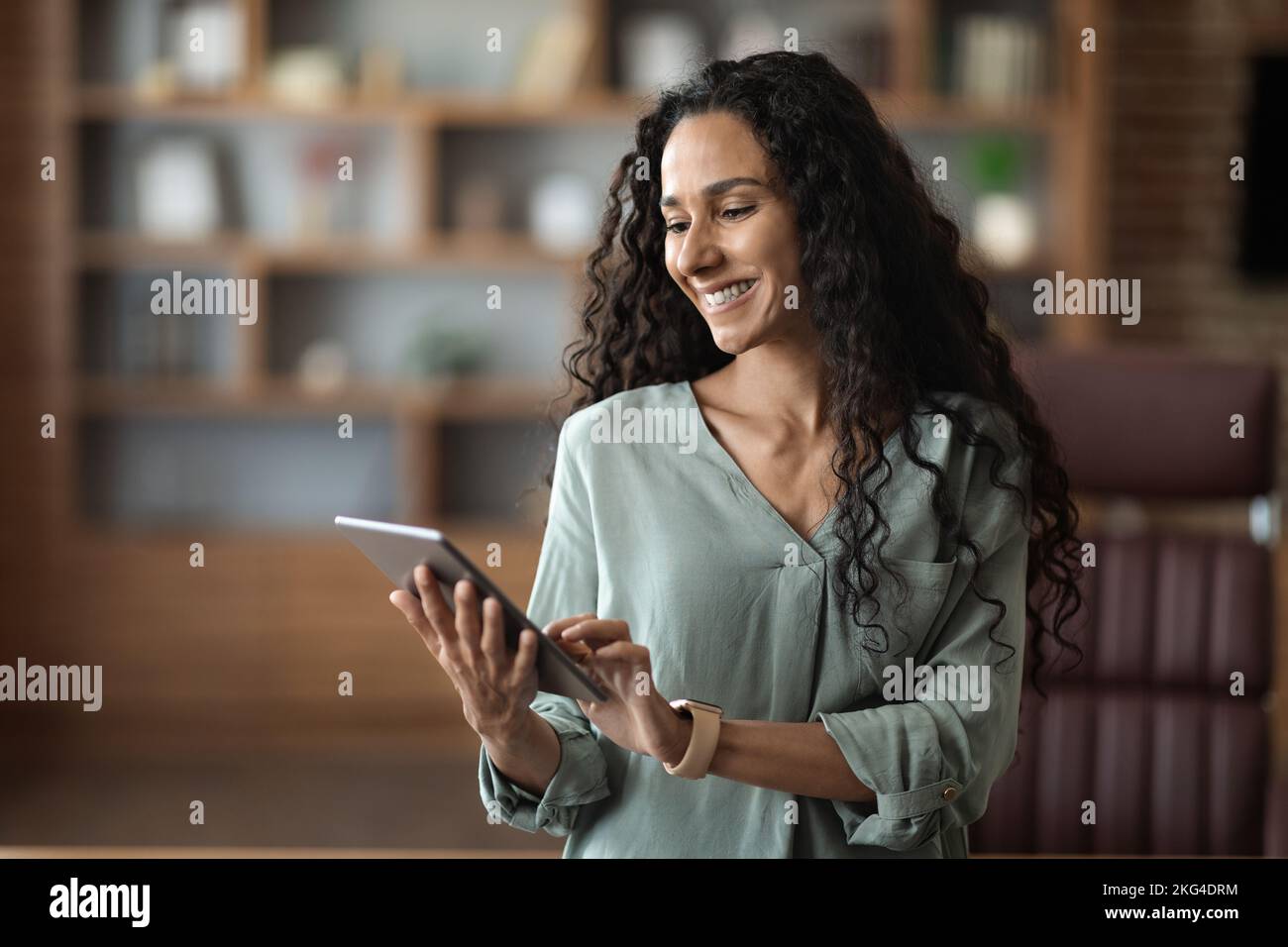 Portrait of smart young entrepreneur woman using her digital tablet Stock Photo