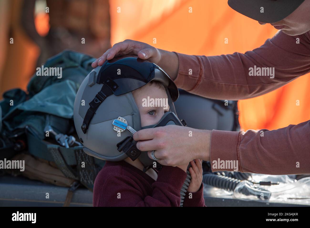 A Child Tries On A Pilot Helmet During Range Day At Draughon Range Near a-child-tries-on-a-pilot-helmet-during-range-day-at-draughon-range-near