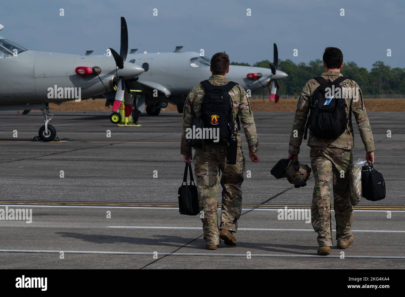 U.S. Air Force 1st Lt. Dylan Raess, left, 319th Special Operations Squadron U-28A combat systems operator, and Capt. Kevin Montes-Gregsamer,  319th SOS U-28A pilot, walk to a U-28A Draco to begin pre-flight operations at Duke Field, Fla., Oct. 28, 2022. The U-28A is a modified, single-engine Pilatus PC-12 aircraft and is part of the Air Force Special Operations Command’s manned, airborne intelligence, surveillance, and reconnaissance fleet. Stock Photo