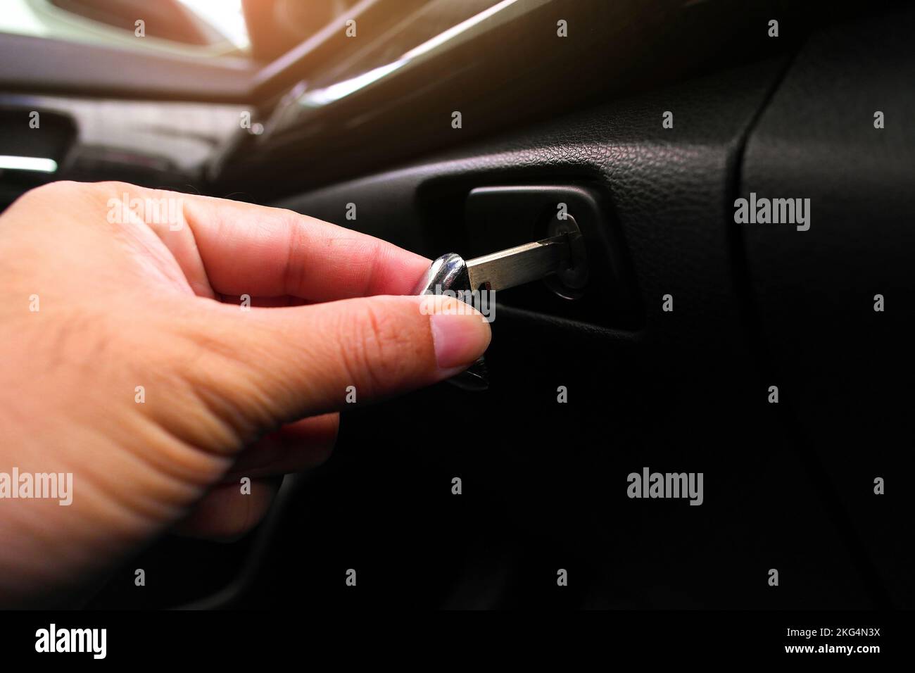 The driver hand is locking the document compartment in the car with the
