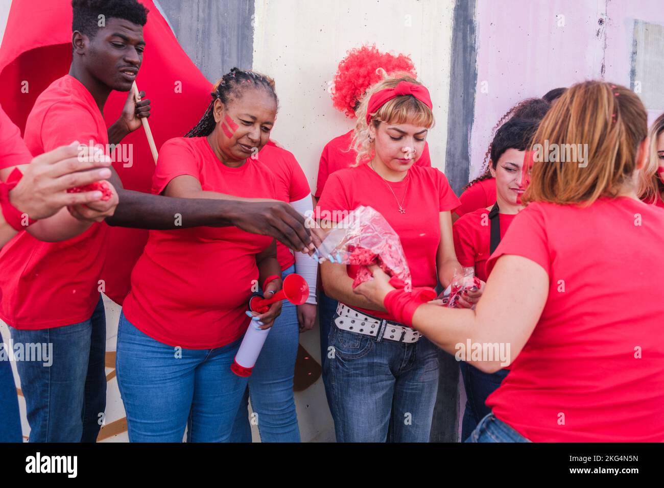Mixed group of fans handing out confetti to celebrate the successes of ...