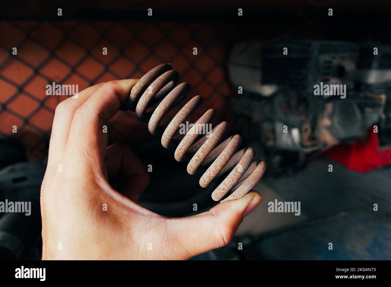 Metal valve spring was rusting on a mechanic hand in the auto repair garage Stock Photo Alamy