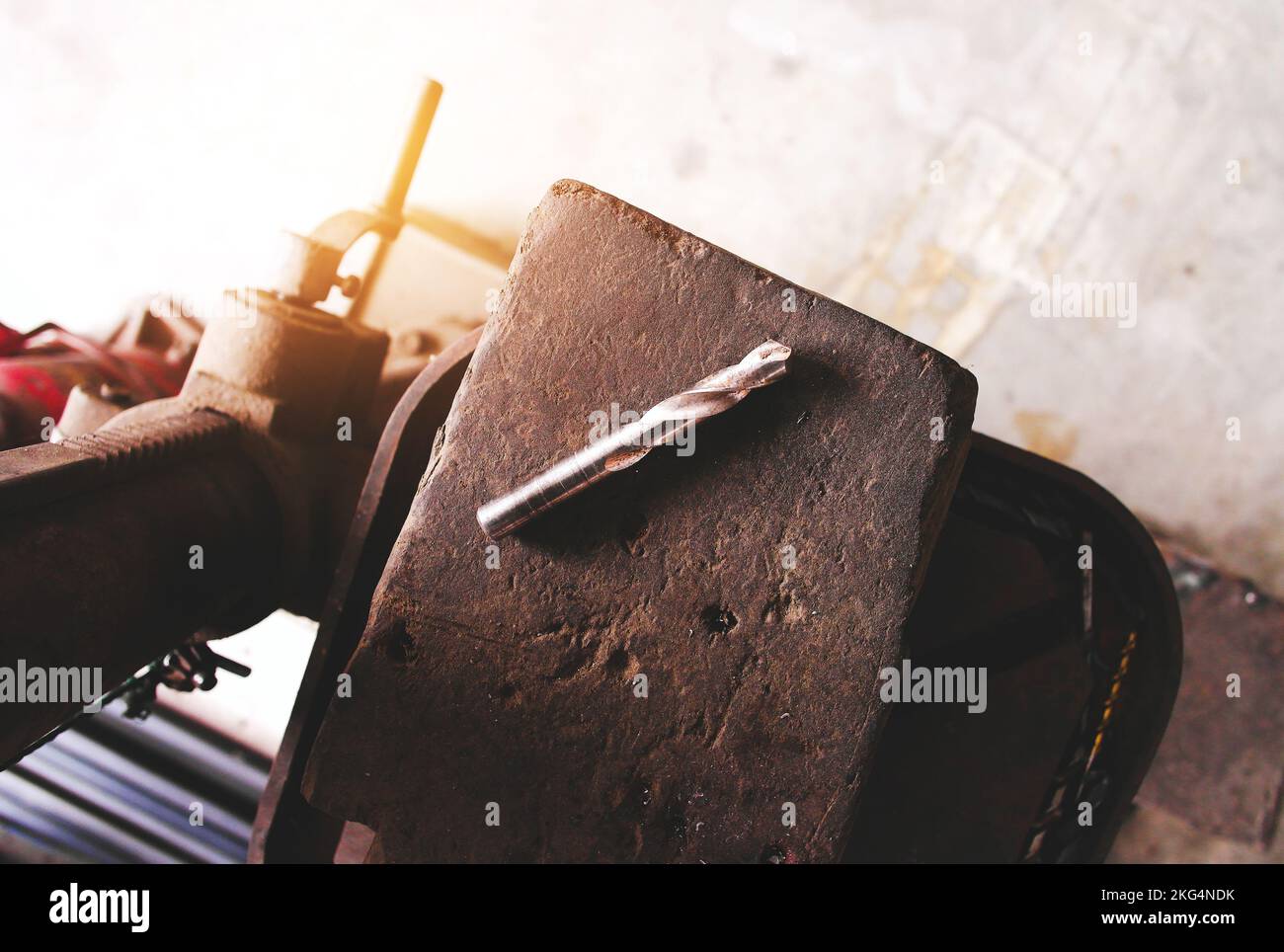 Metal drill bits for drilling machines are placed on wood in the factory industrial Stock Photo