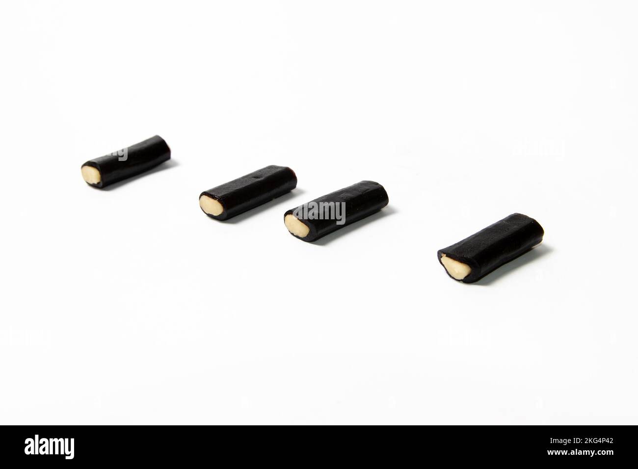 Black licorice candy with filling on white background Stock Photo Alamy