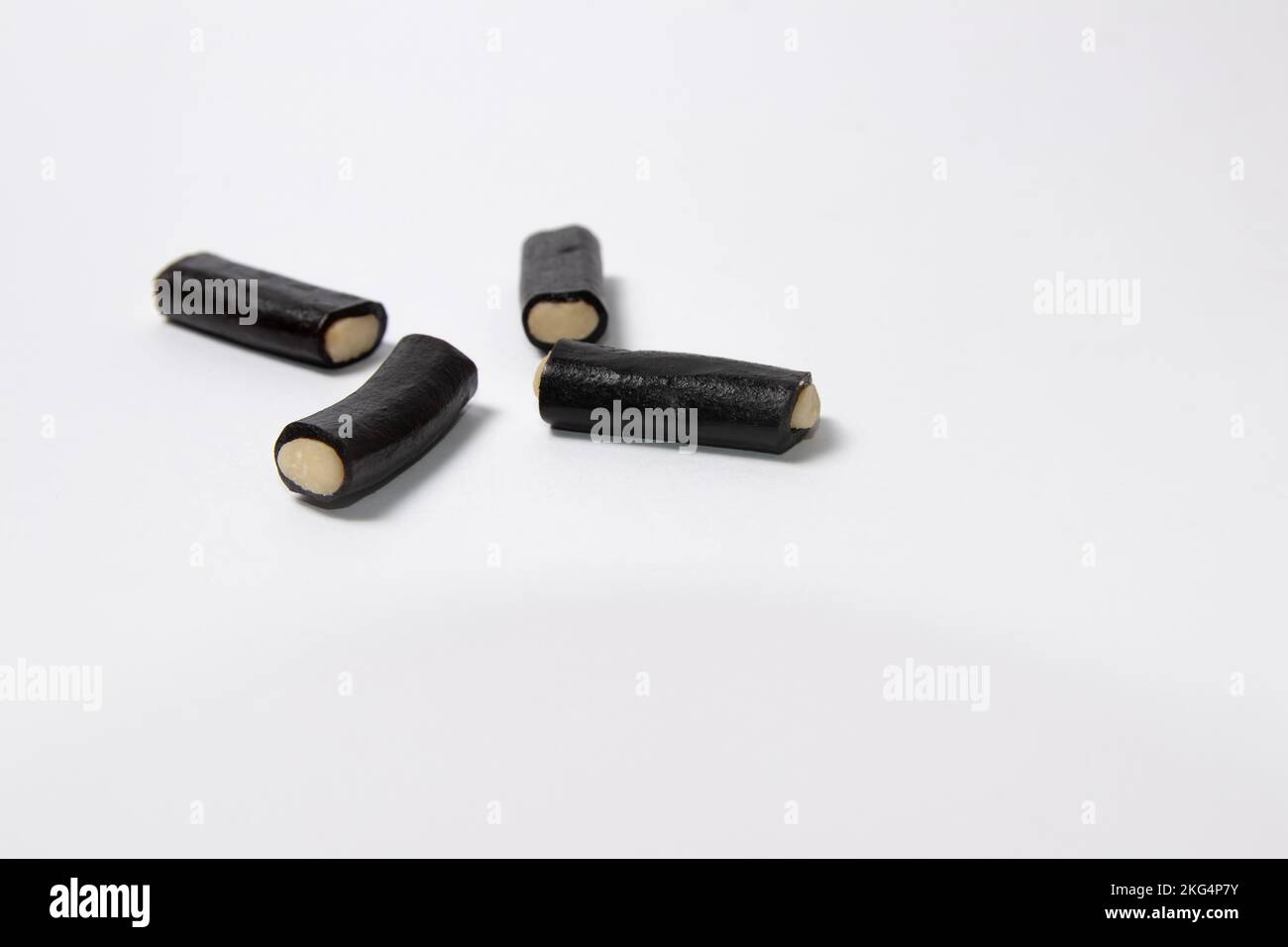 Black licorice candy with filling on white background Stock Photo Alamy