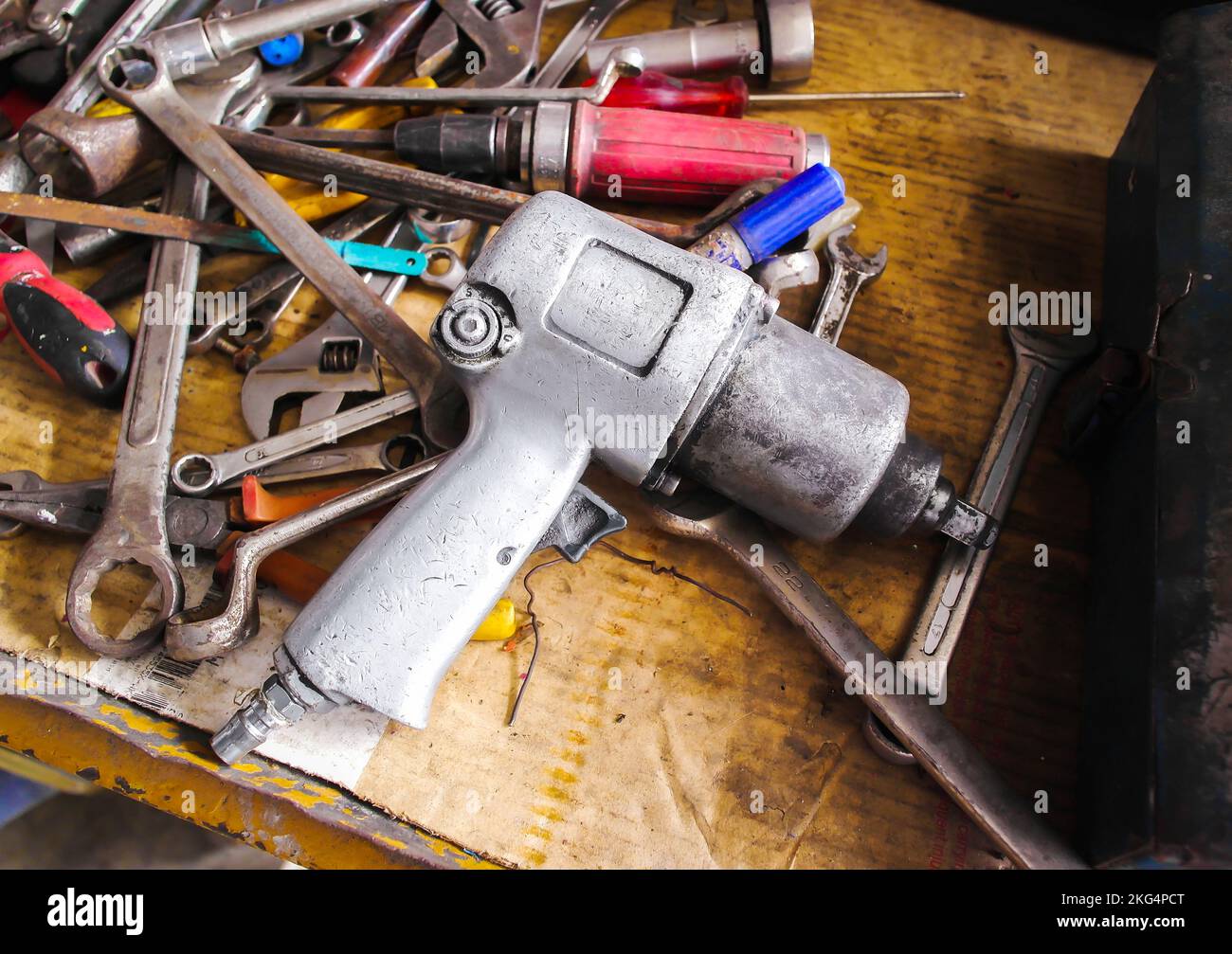 An old air impact wrench on a hand tool rack in the auto repair garage