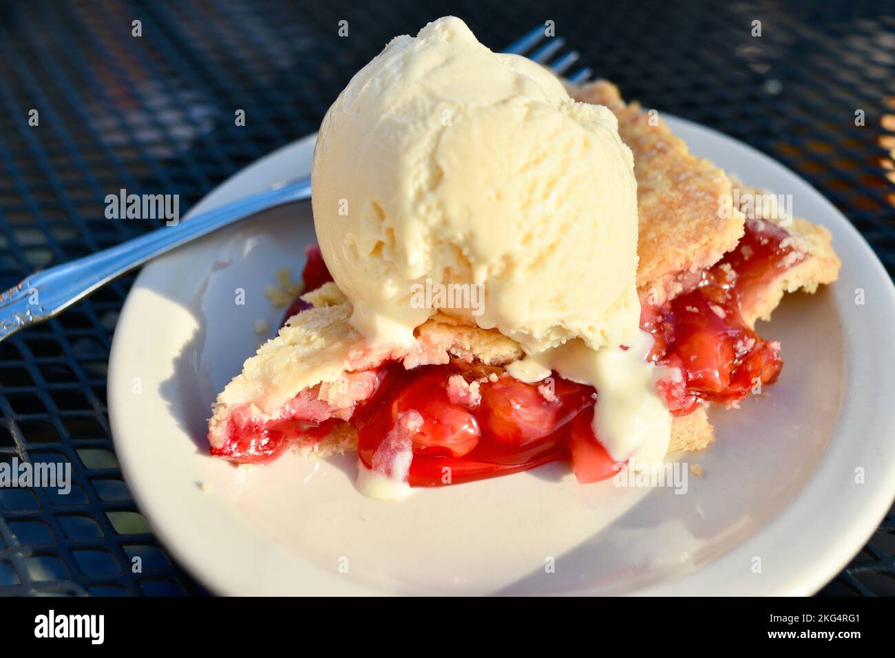 Piece of fresh baked cherry pie served a la mode with scoop of ice cream at The Old Post Office Restaurant, Door County, Ephraim, Wisconsin, USA Stock Photo