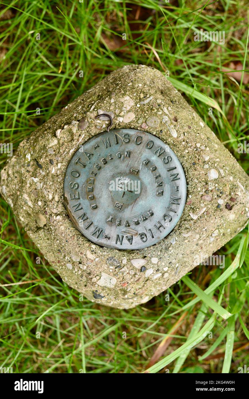 Survey marker medallion mounted in cement at the Upper Range Light at The Ridges Sanctuary, Door County, Baileys Harbor, Wisconsin, USA Stock Photo