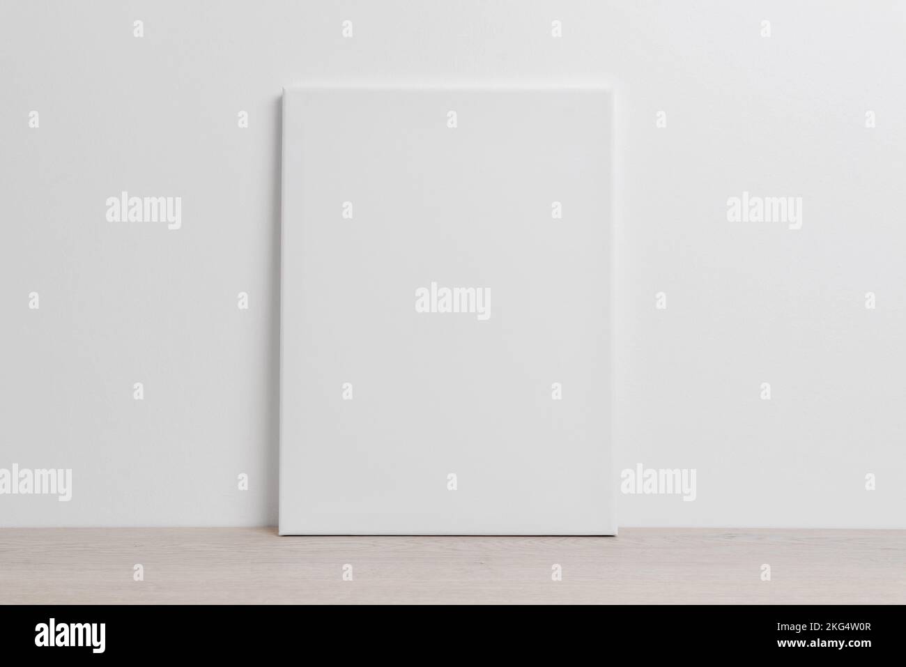 Art canvas mockup on the floor leaning against the white wall Stock Photo
