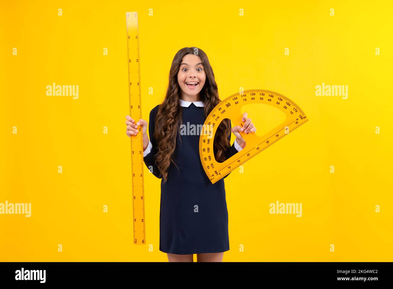 Schoolgirl in school uniform hold mathematics measure. Metric