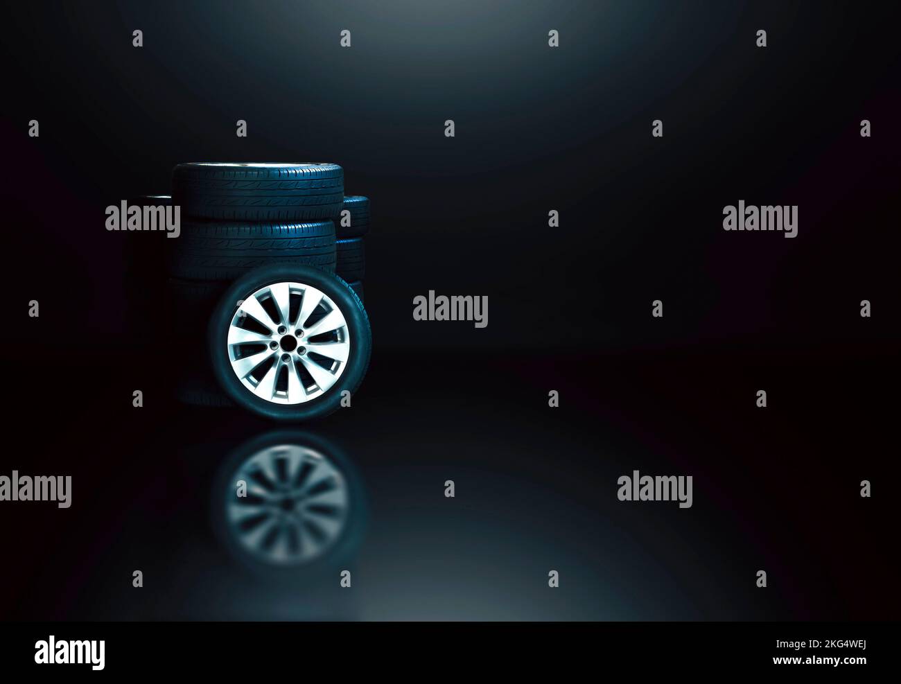 Car rims with tires and tire stacks with reflection, black background