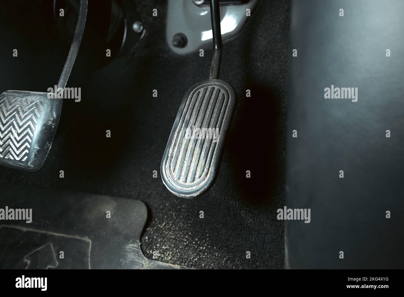 Accelerator pedal of a car with dirty stains on the pedals in a car