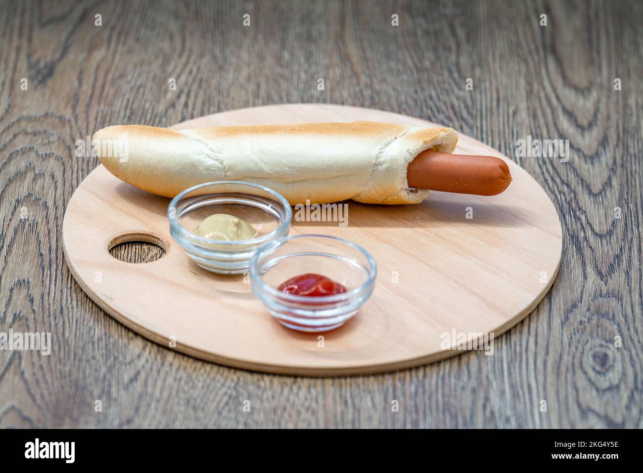 hot dog in a roll with mustard and ketchup Stock Photo