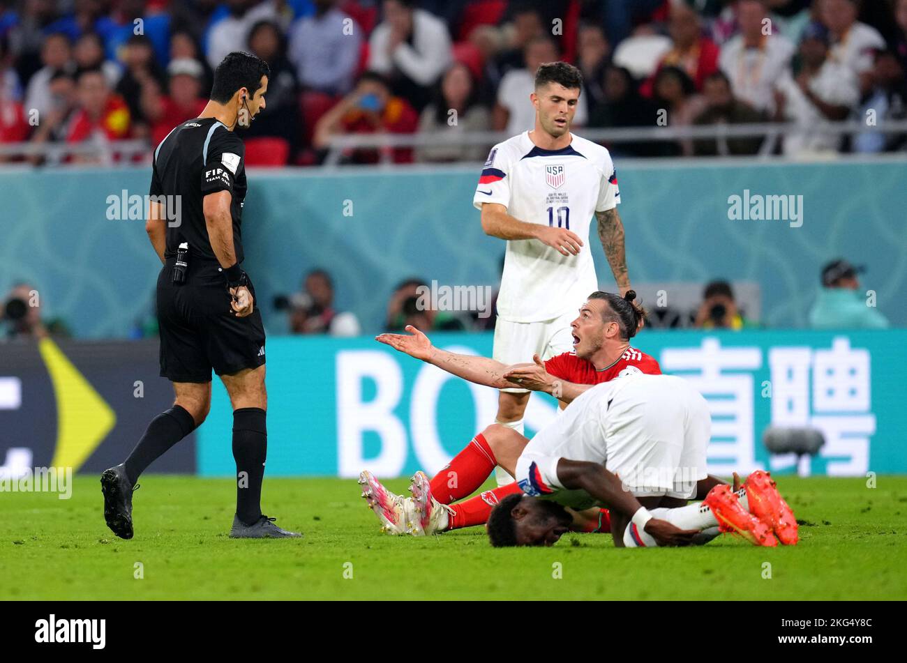 Referee Abdulrahman Al-Jassim speaks to Wales' Gareth Bale after a foul on USA's Yunus Musah during the FIFA World Cup Group B match at the Ahmad Bin Ali Stadium, Al-Rayyan. Picture date: Monday November 21, 2022. Stock Photo