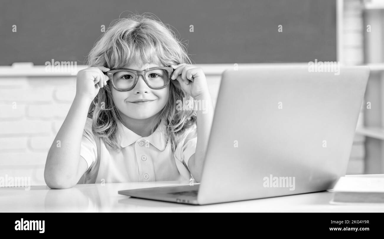 e-learning. child studying on computer. smiling teen boy in classroom. back to school. Stock Photo