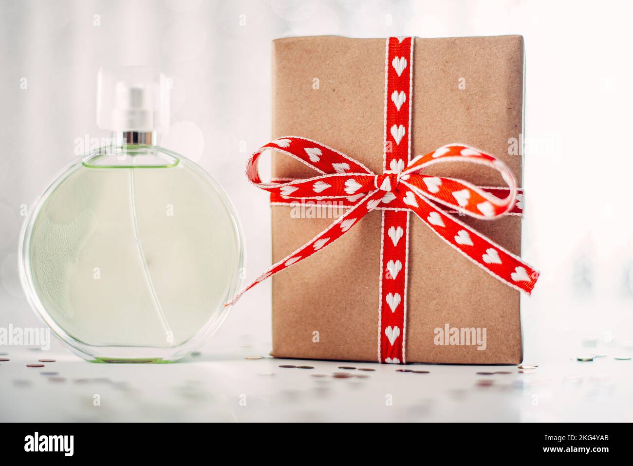 Glass fragrant perfume bottle with red gift box. Stock Photo