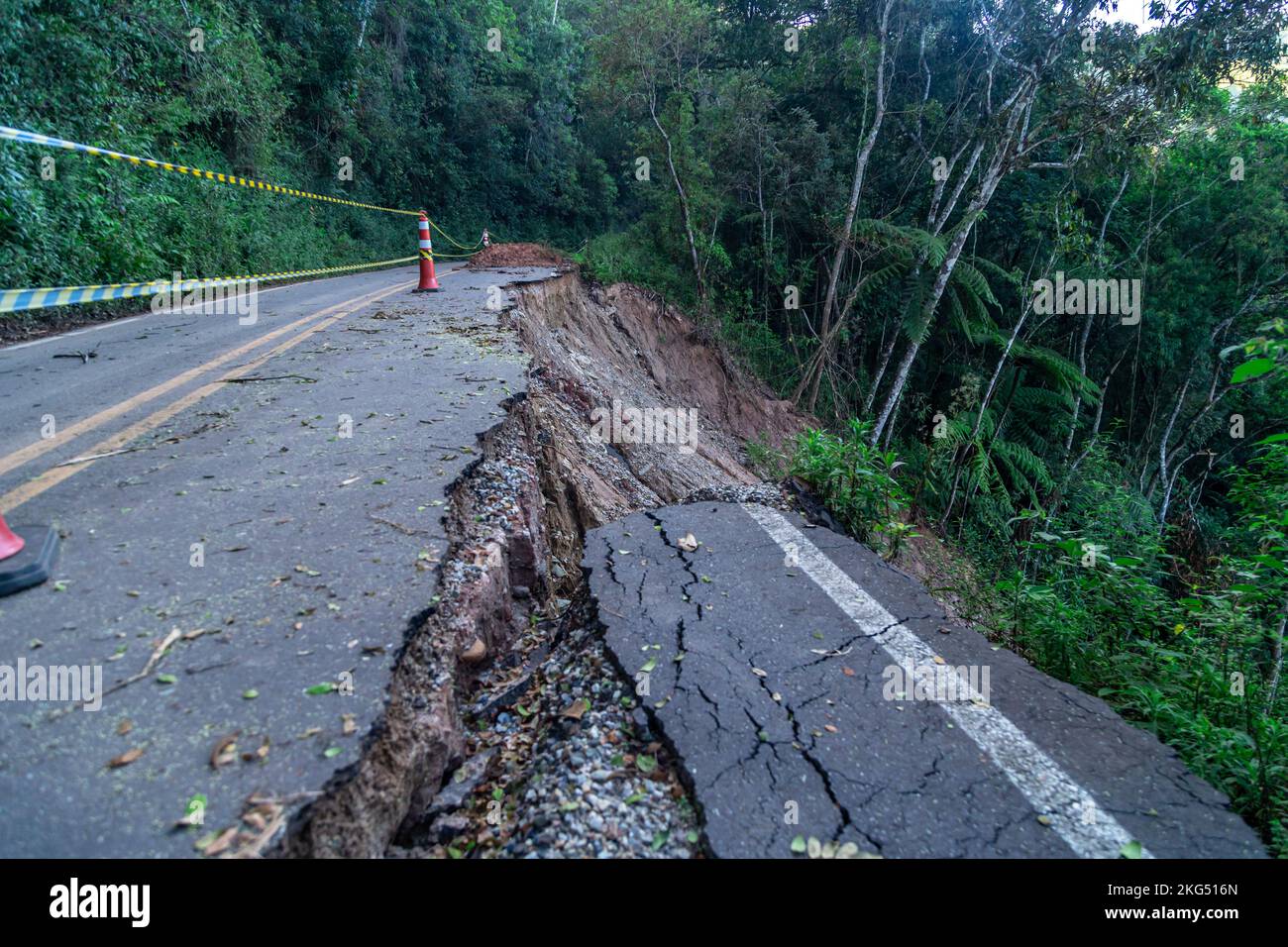 asphalt road damaged by a landslide in a mountain area Stock Photo