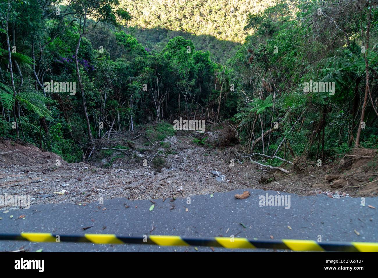 asphalt road damaged by a landslide in a mountain area Stock Photo