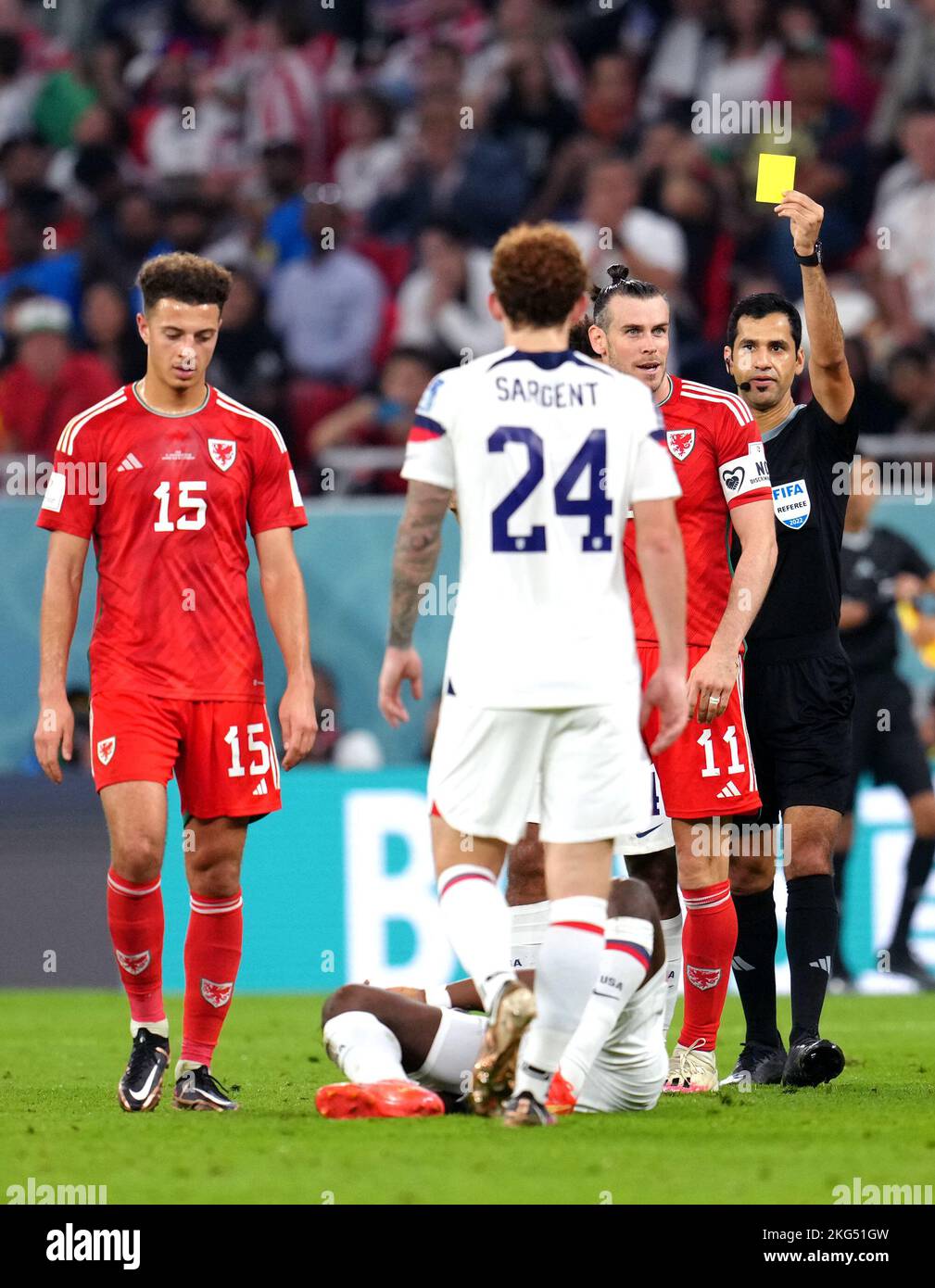 Wales' Gareth Bale is shown a yellow card by referee Abdulrahman Al-Jassim after a foul on USA's Yunus Musah during the FIFA World Cup Group B match at the Ahmad Bin Ali Stadium, Al-Rayyan. Picture date: Monday November 21, 2022. Stock Photo