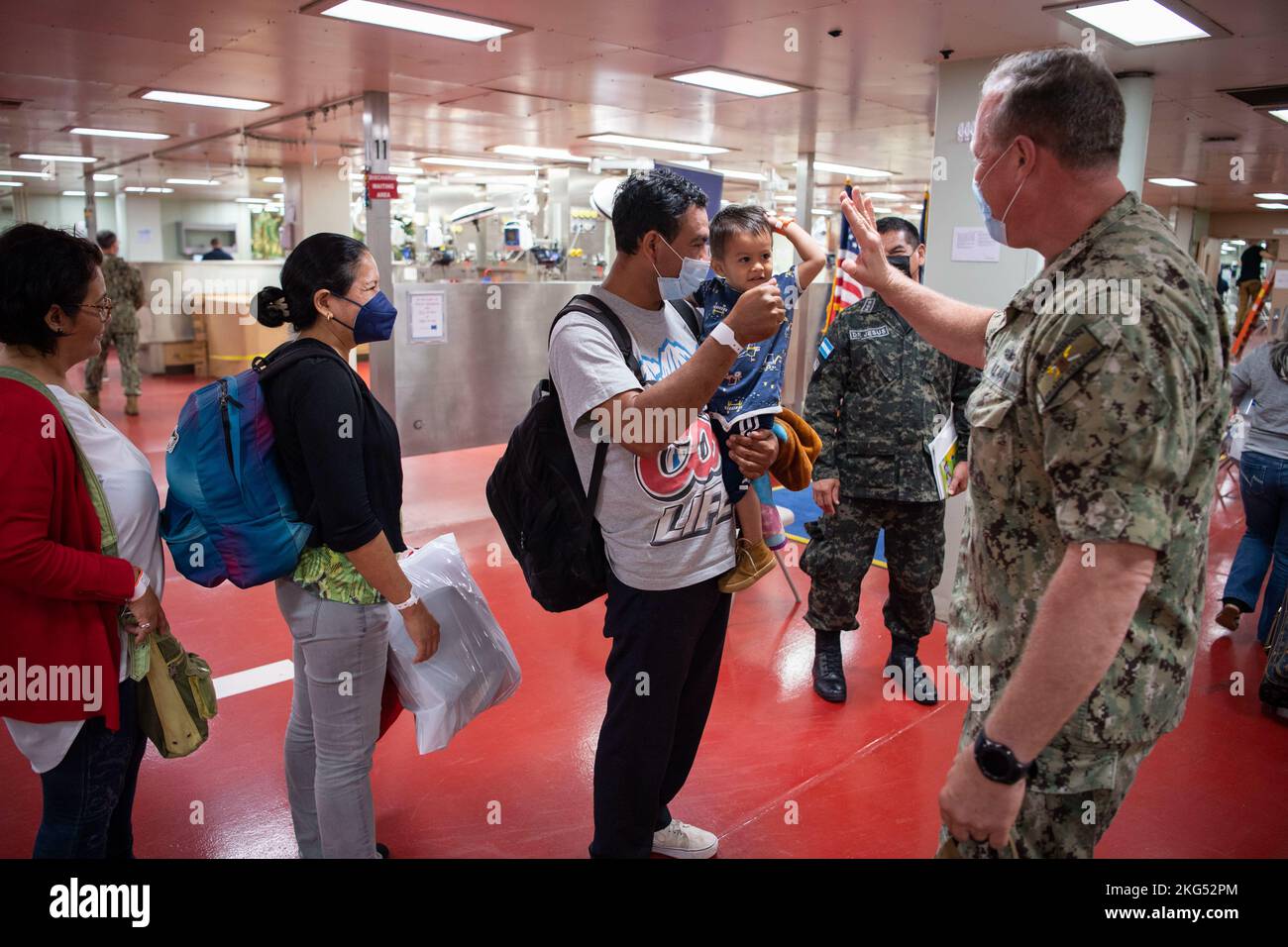 221030-N-TR141-1004 PUERTO BARRIOS, Guatemala (Oct. 30, 2022) Capt. Bryan Carmichael, commodore of Amphibious Squadron (PHIBRON) 4, says goodbye to patients from Guatemala as they depart the hospital ship USNS Comfort (T-AH 20) after receiving medical care aboard the ship during Continuing Promise 22 in Puerto Barrios, Guatemala, Oct. 30, 2022. Comfort is deployed to U.S. 4th Fleet in support of CP22, a humanitarian assistance and goodwill mission conducting direct medical care, expeditionary veterinary care, and subject matter expert exchanges with five partner nations in the Caribbean, Centr Stock Photo