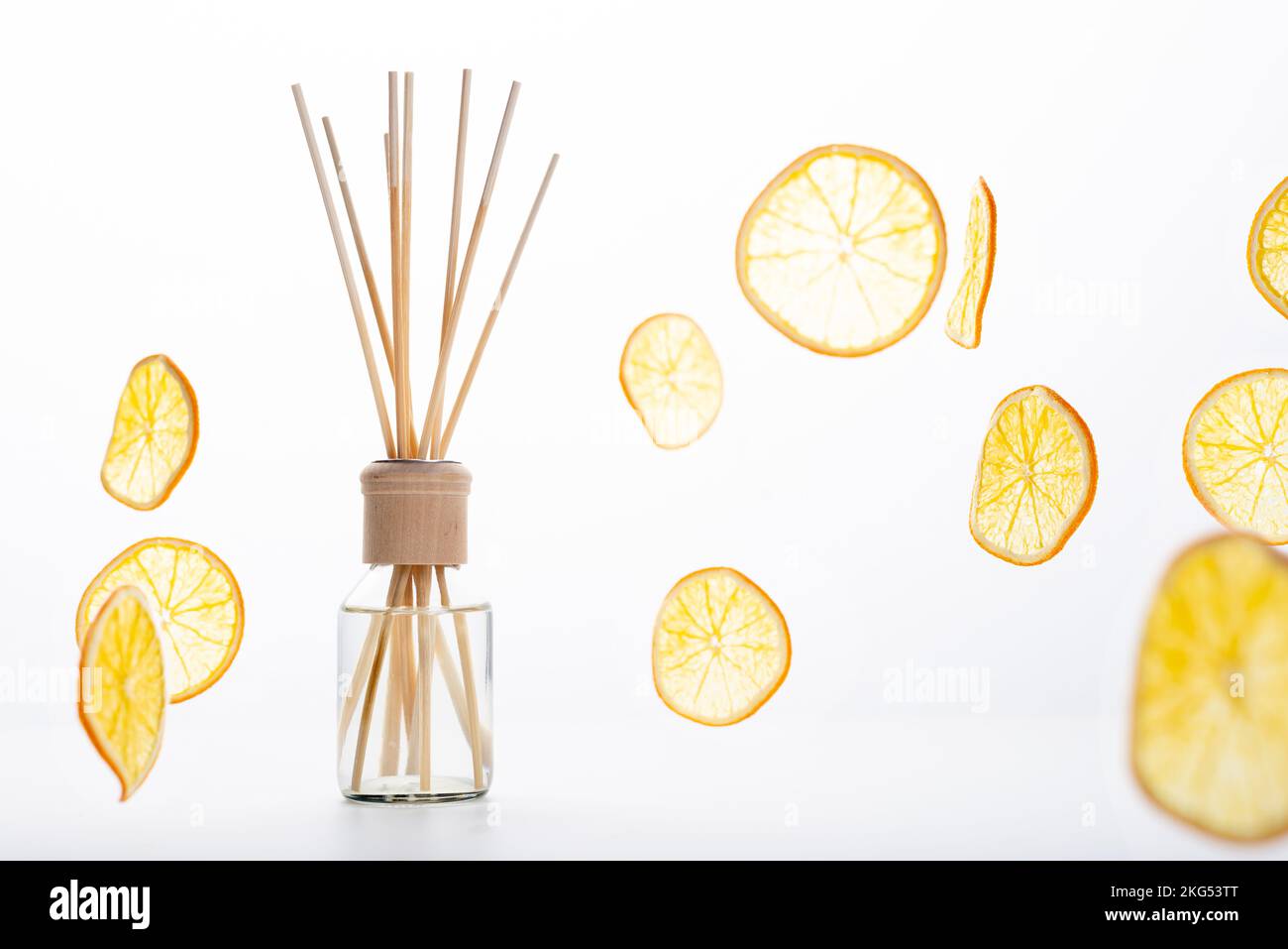 Reed diffuser and different citrus fruits on table. Stock Photo