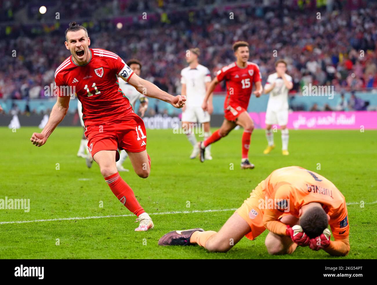 Wales' Gareth Bale (left) celebrates after scoring their side's first goal of the game from the penalty spot during the FIFA World Cup Group B match at the Ahmad Bin Ali Stadium, Al-Rayyan. Picture date: Monday November 21, 2022. Stock Photo