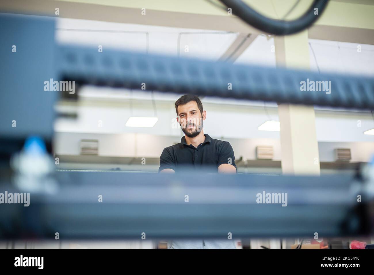 Professional worker printmaker technician operator works in printing