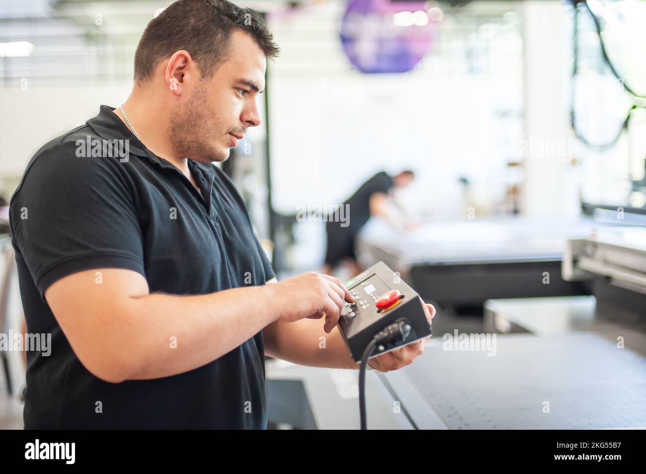 Professional worker printmaker technician operator works in printing