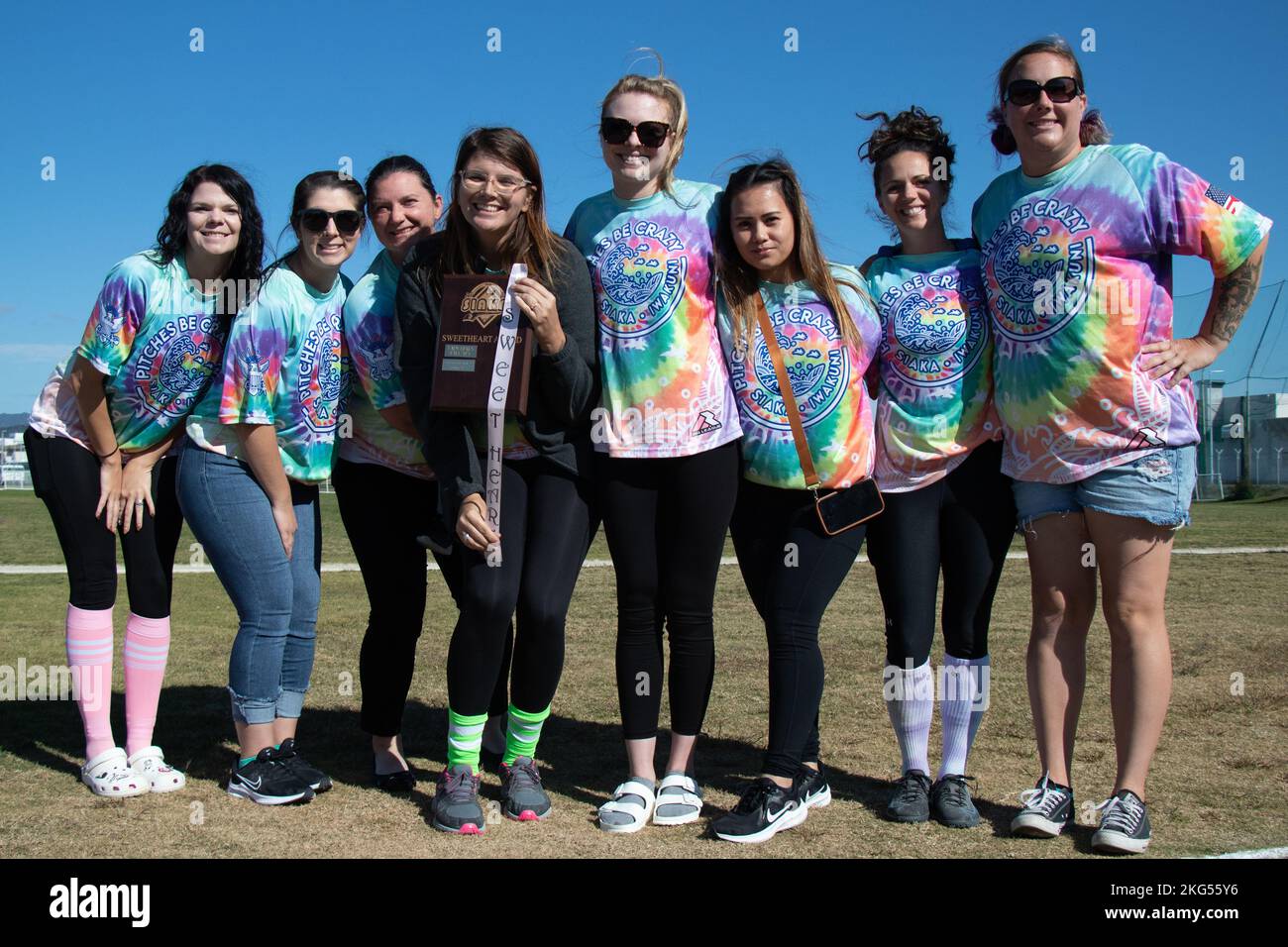 Women with the Pitches Be Crazy team and Spouses Iwakuni Area Kickball Association (SIAKA) pose for a group photo upon receiving the sweetheart award during the 2022 SIAKA tournament awards presentation at Marine Corps Air Station Iwakuni, Japan, Oct. 30, 2022. Each year SIAKA holds seasonal kickball tournaments for military spouses and female service members to connect, build friendships, and engage in friendly competition while on their tour at the air station. Stock Photo