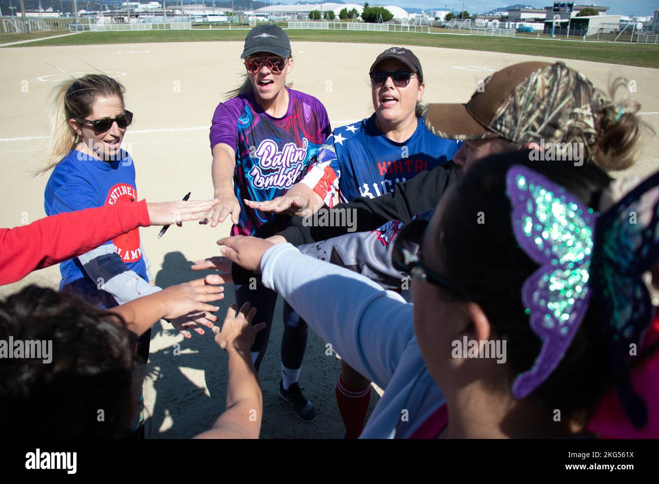 Women with the Spouses Iwakuni Area Kickball Association (SIAKA) cheer prior to an allstars
