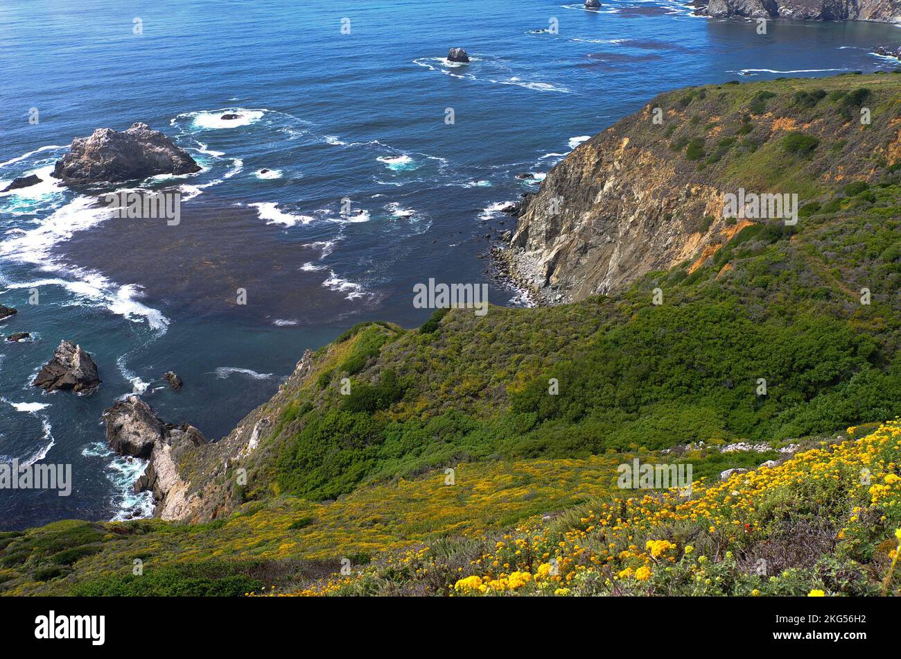 An aerial shot of the Big Sur cliff in California with waves hitting ...