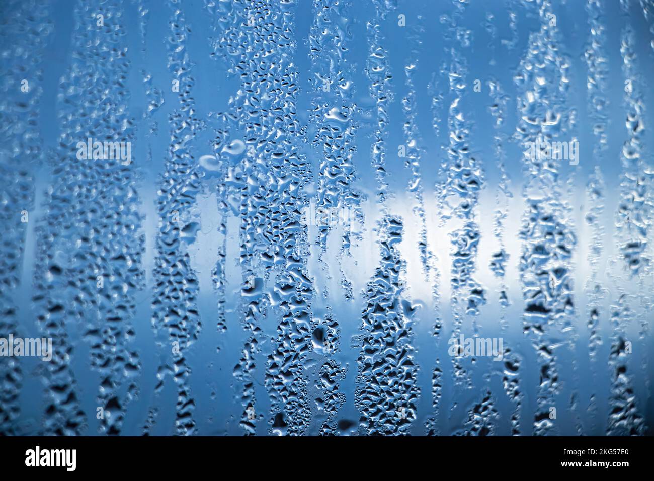 Texture of misted glass in autumn. Drops of water on window in rainy weather. Abstract background. Stock Photo