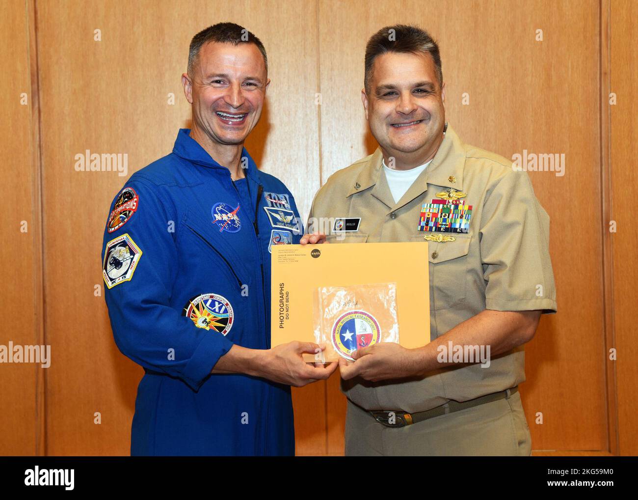 JOINT BASE SAN ANTONIO-FORT SAM HOUSTON – (Oct. 31, 2022) – NASA Astronaut, U.S. Army Col. Andrew Morgan (left) returns items he carried to the International Space Station (ISS) to U.S. Navy Capt. Ewell Hollis, executive officer of Naval Medical Research Unit (NAMRU) San Antonio during a presentation ceremony held at the Brooke Army Medical Center’s Putnam Auditorium.  Morgan, the first Army physician in space, launched from the Baikonur Cosmodrome, Kazakhstan, to the ISS aboard a Soyuz (Union) MS-13 spacecraft on July 20, 2019. During his time aboard the space station, Morgan participated in Stock Photo