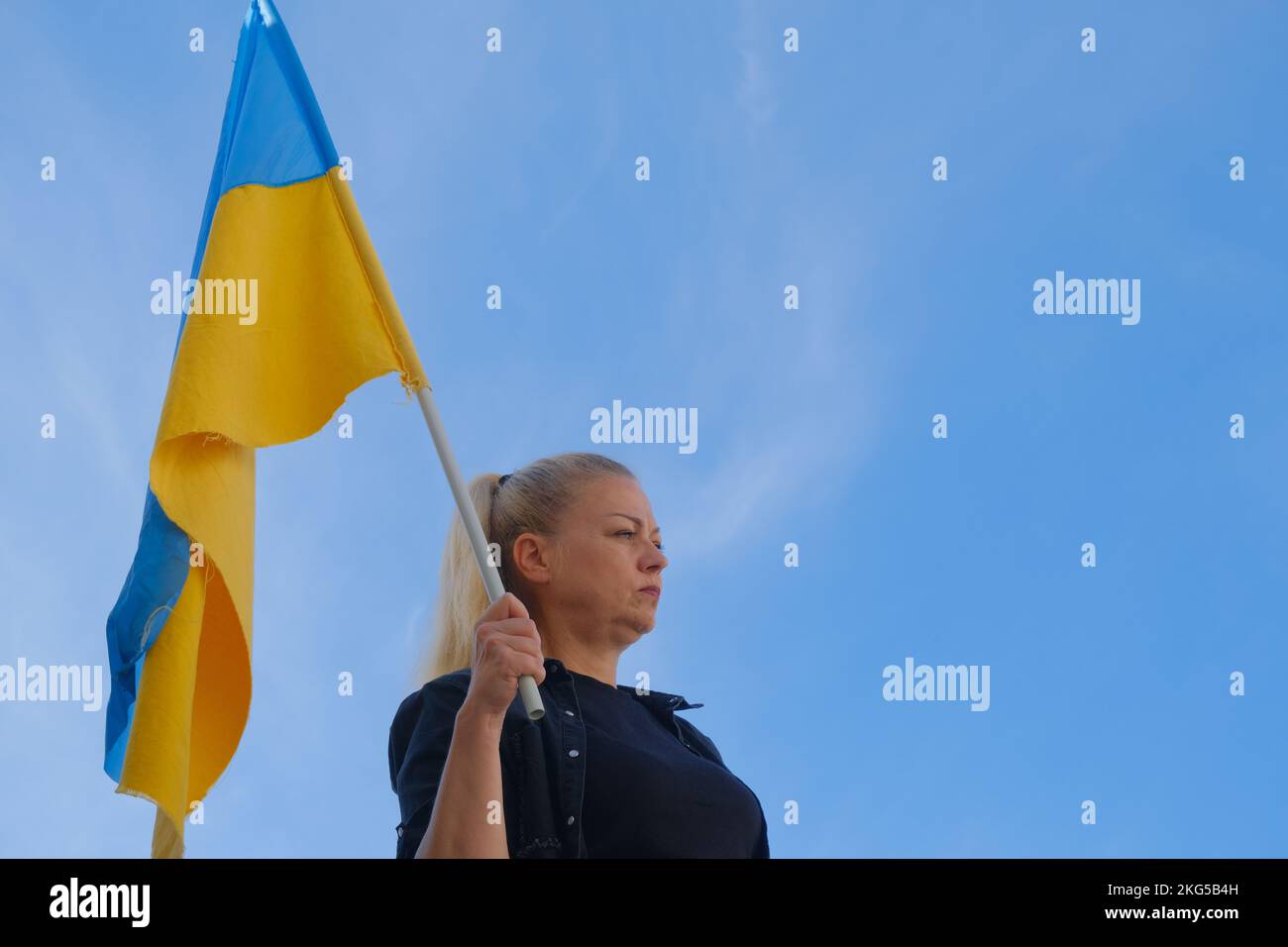The Ukraine-Russia war was protested in Turkey. Woman holding the flag of Ukraine. Stock Photo