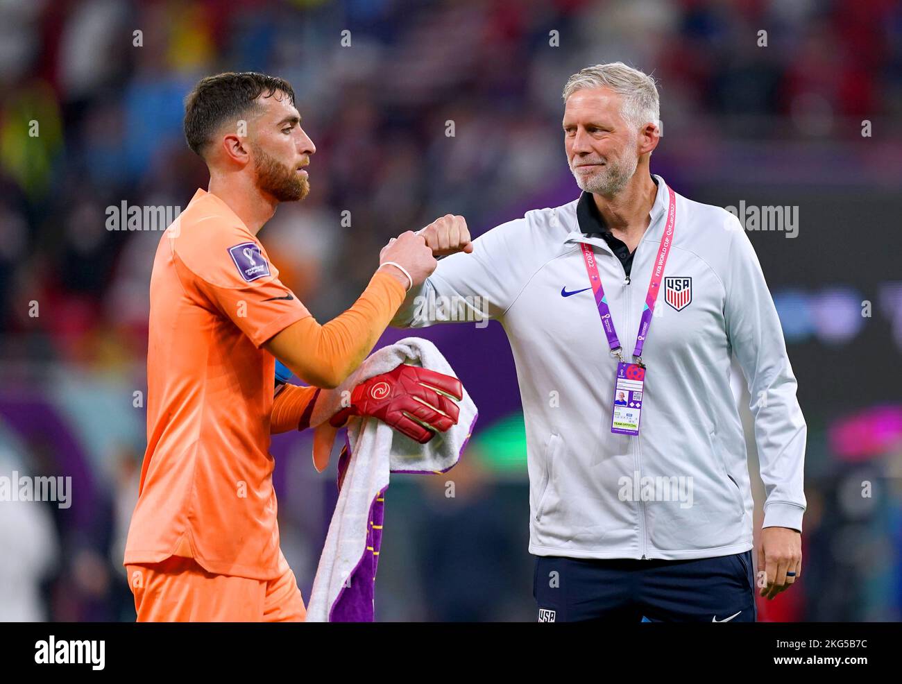 USA goalkeeper Matt Turner (left) bumps fists with team coach Travis