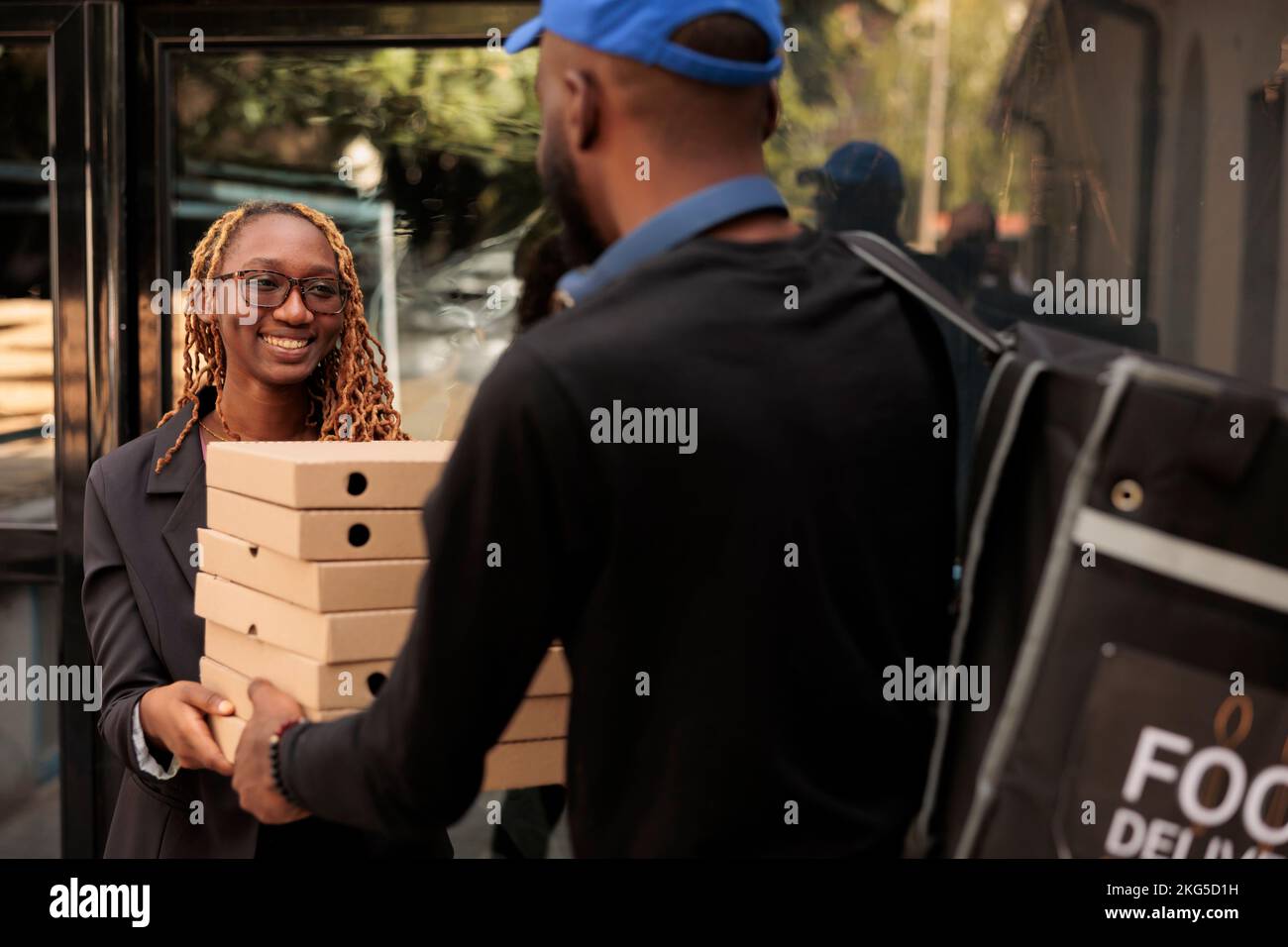 Business lunch delivery, cheerful client holding pizza boxes pile