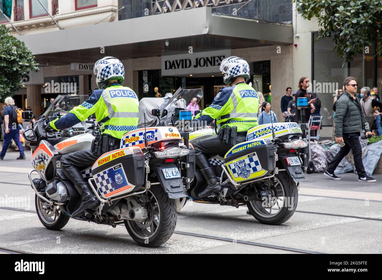 Melbourne Victoria police officers, male police officers sit astride their highway patrol motorbikes following a protest march in Melbourne, Australia Stock Photo
