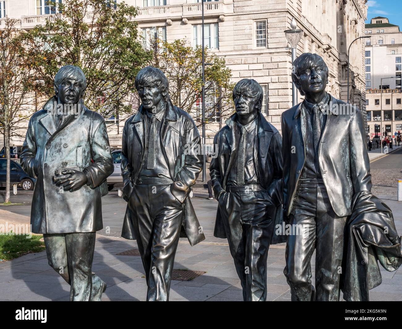 Street scene in Liverpool with the bronze statues of the famous Beatles pop group, with Paul McCartney, George Harrison, Ringo Starr, John Lennon Stock Photo