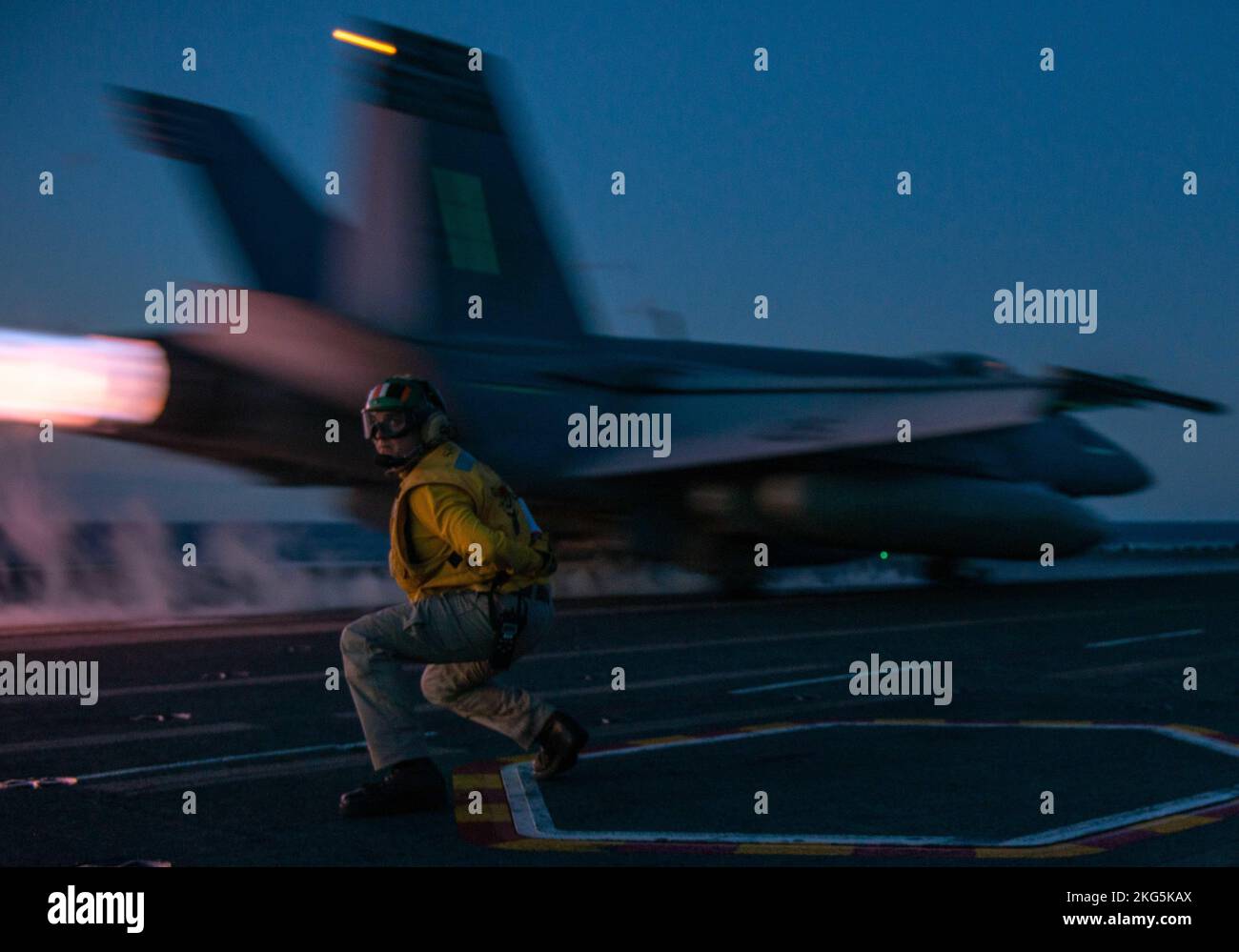 221005-N-LI114-2066 SEA OF JAPAN (Oct. 5, 2022) Lt. William Peters, from Webster, Massachusetts, signals for the launch of an F/A-18E Super Hornet, attached to the Dambusters of Strike Fighter Squadron (VFA) 195,  from the flight deck of the U.S. Navy’s only forward-deployed aircraft carrier, USS Ronald Reagan (CVN 76), in the Sea of Japan, Oct. 5. Ronald Reagan, the flagship of Carrier Strike Group 5, provides a combat-ready force that protects and defends the United States, and supports alliances, partnerships and collective maritime interests in the Indo-Pacific region. Stock Photo