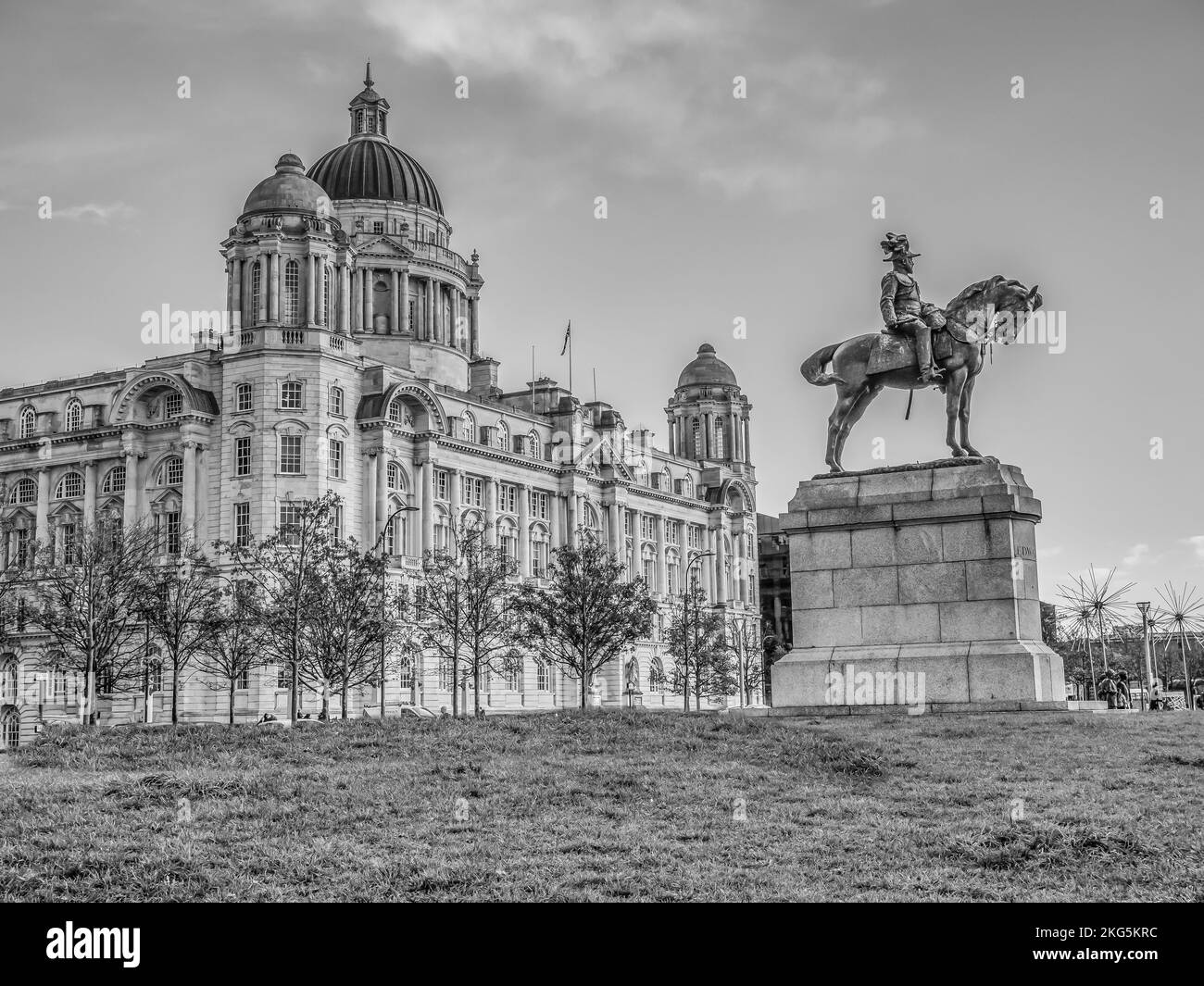 Street scenes in Liverpool seen here from the Pier Head promenade area looking towards the Royal Liver buildings with the statue of King Edward VII Stock Photo
