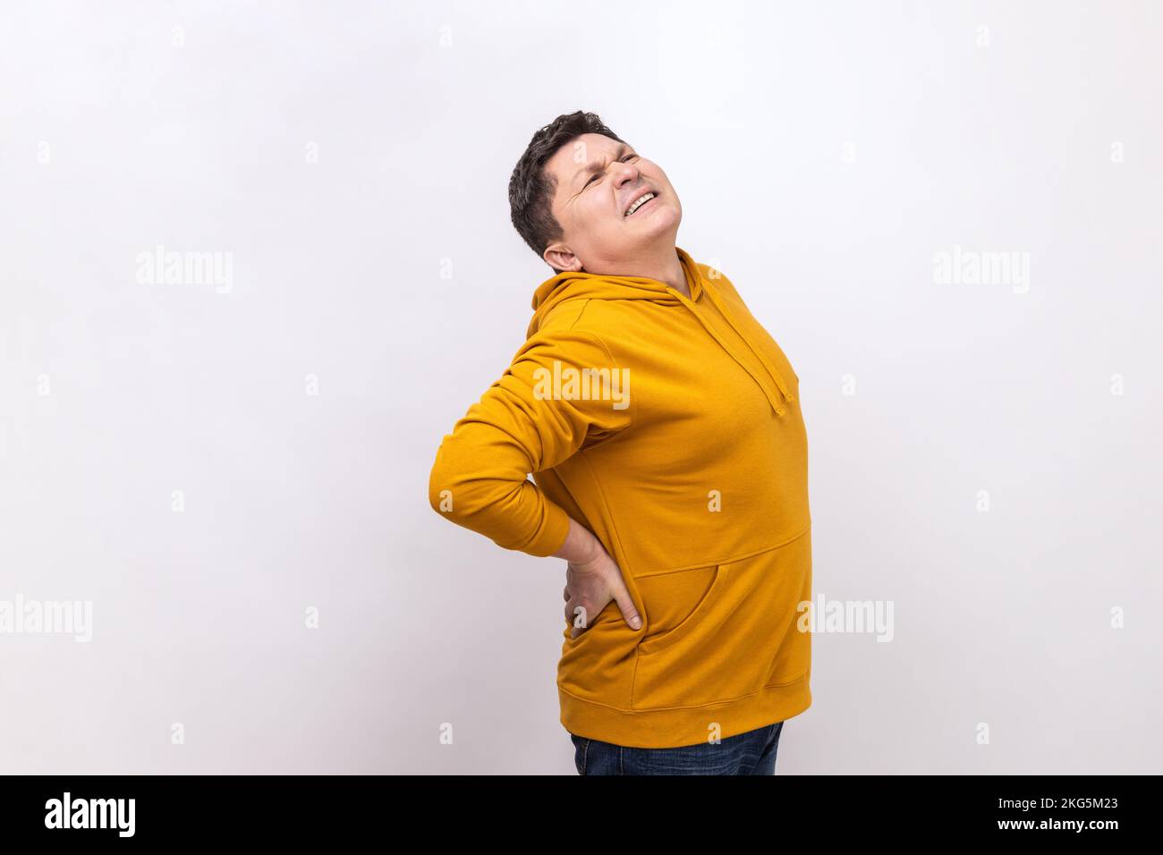 Side view of man suffering back ache, lower lumbar painful